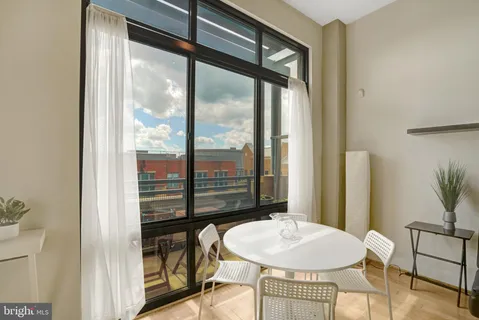 a very nice looking dining room with a large window