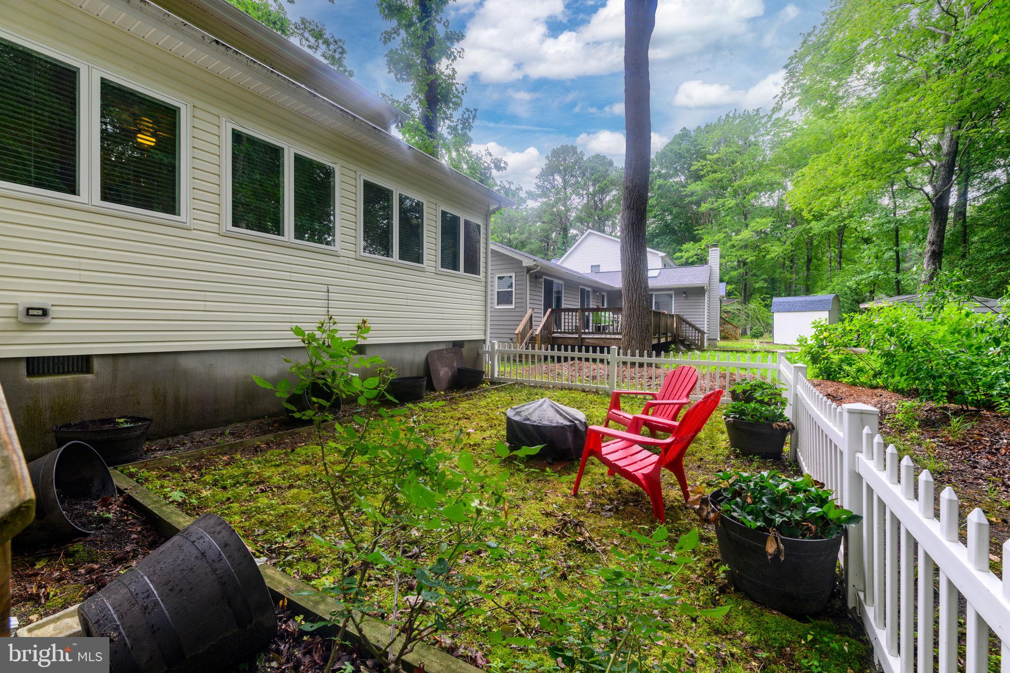 10 Gloucester Road Ocean Pines, MD 21811 - Photo 27 of 37 a backyard of a house with a swing table and chairs