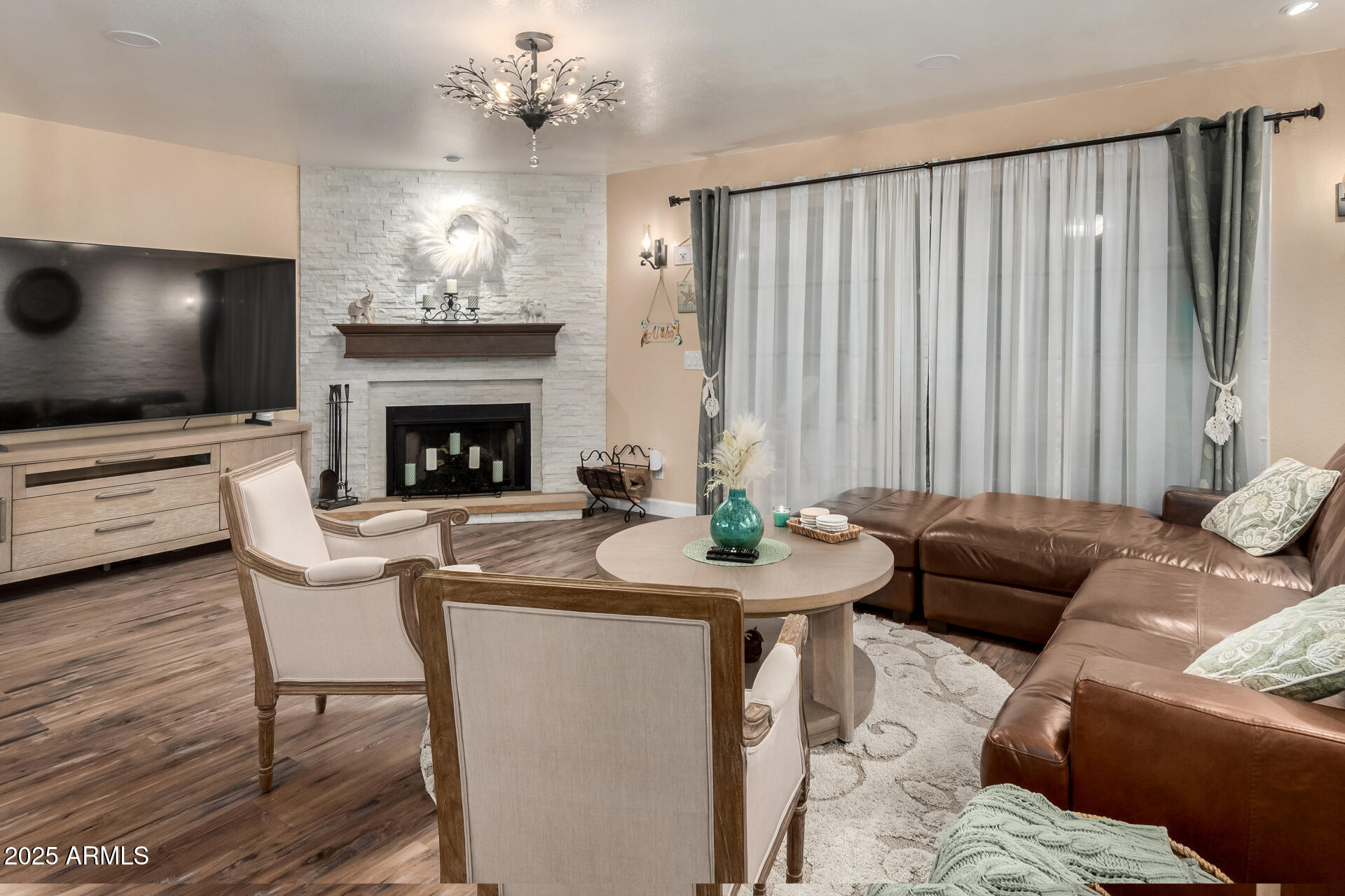 5956 East Phelps Road Scottsdale, AZ 85254 - Photo 12 of 60 a living room with furniture and a fireplace