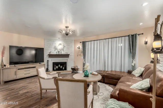 a living room with furniture a clock and a large mirror