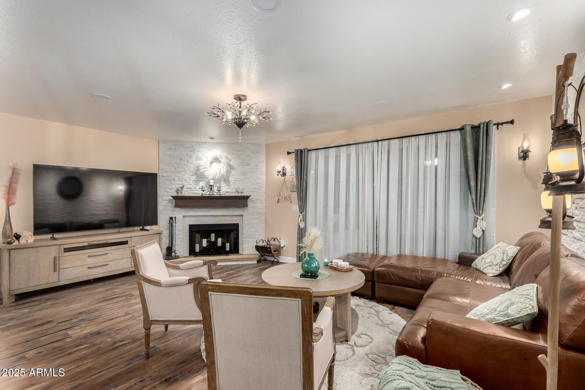 5956 East Phelps Road Scottsdale, AZ 85254 - Photo 13 of 60 a living room with furniture a fireplace and a flat screen tv