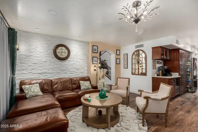 a living room with furniture and a chandelier