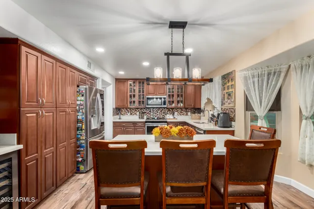 a kitchen with stainless steel appliances granite countertop a sink stove and cabinets