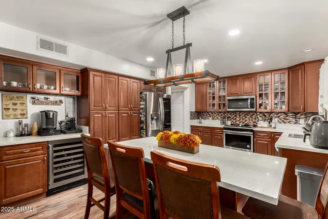 a kitchen with stainless steel appliances granite countertop a refrigerator stove and sink