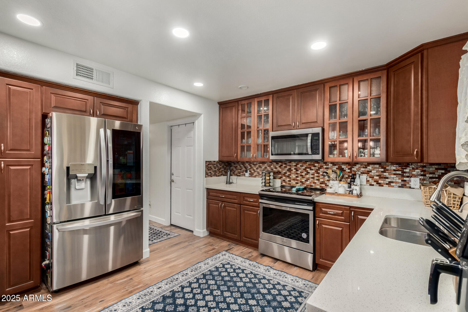 5956 East Phelps Road Scottsdale, AZ 85254 - Photo 23 of 60 a kitchen with stainless steel appliances granite countertop a refrigerator stove and sink