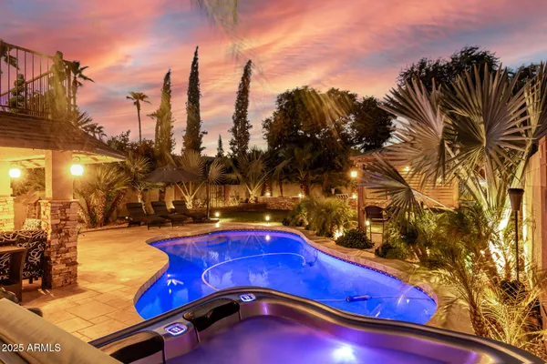 a view of swimming pool with outdoor seating and city view