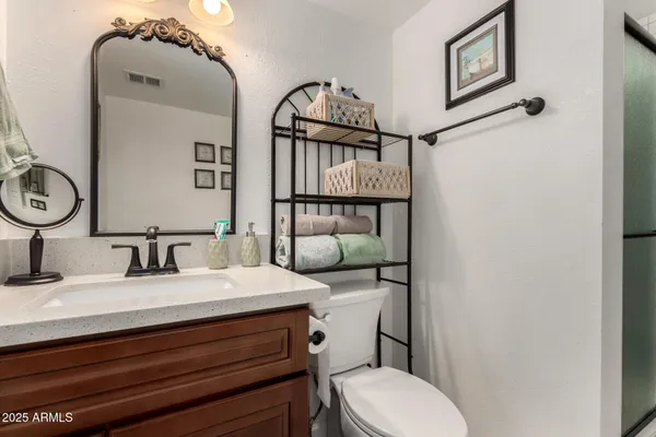 a bathroom with a sink a mirror and a shower