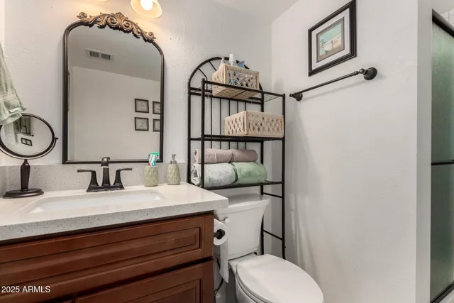 a bathroom with a sink a mirror and a shower