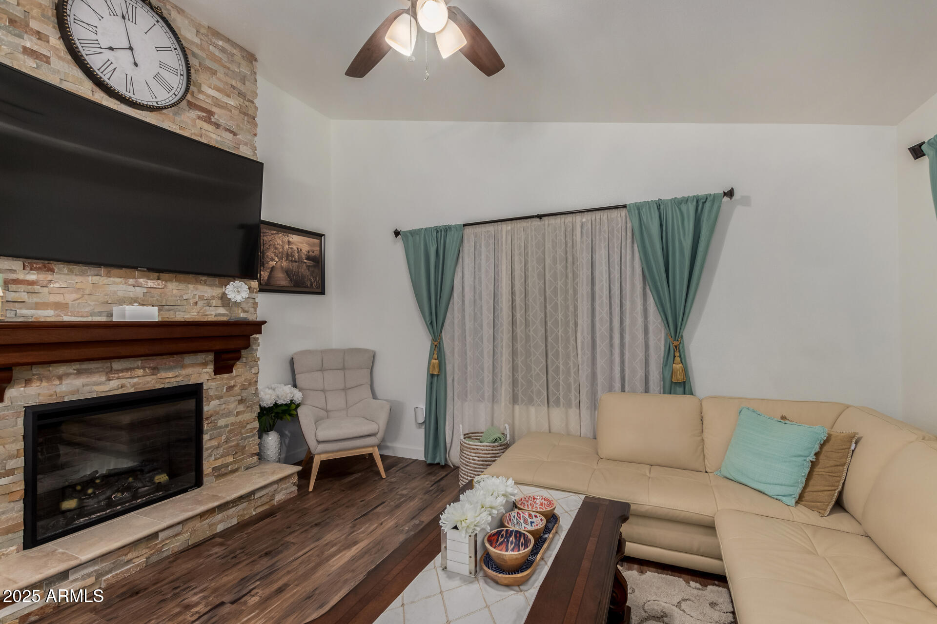5956 East Phelps Road Scottsdale, AZ 85254 - Photo 38 of 60 a living room with furniture a flat screen tv and a fireplace