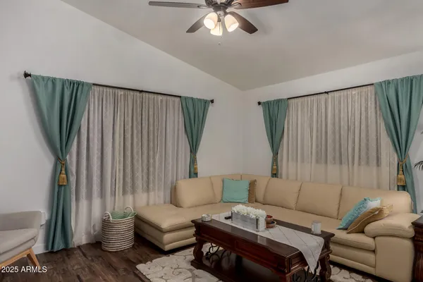 a bedroom with a bed couch and a window