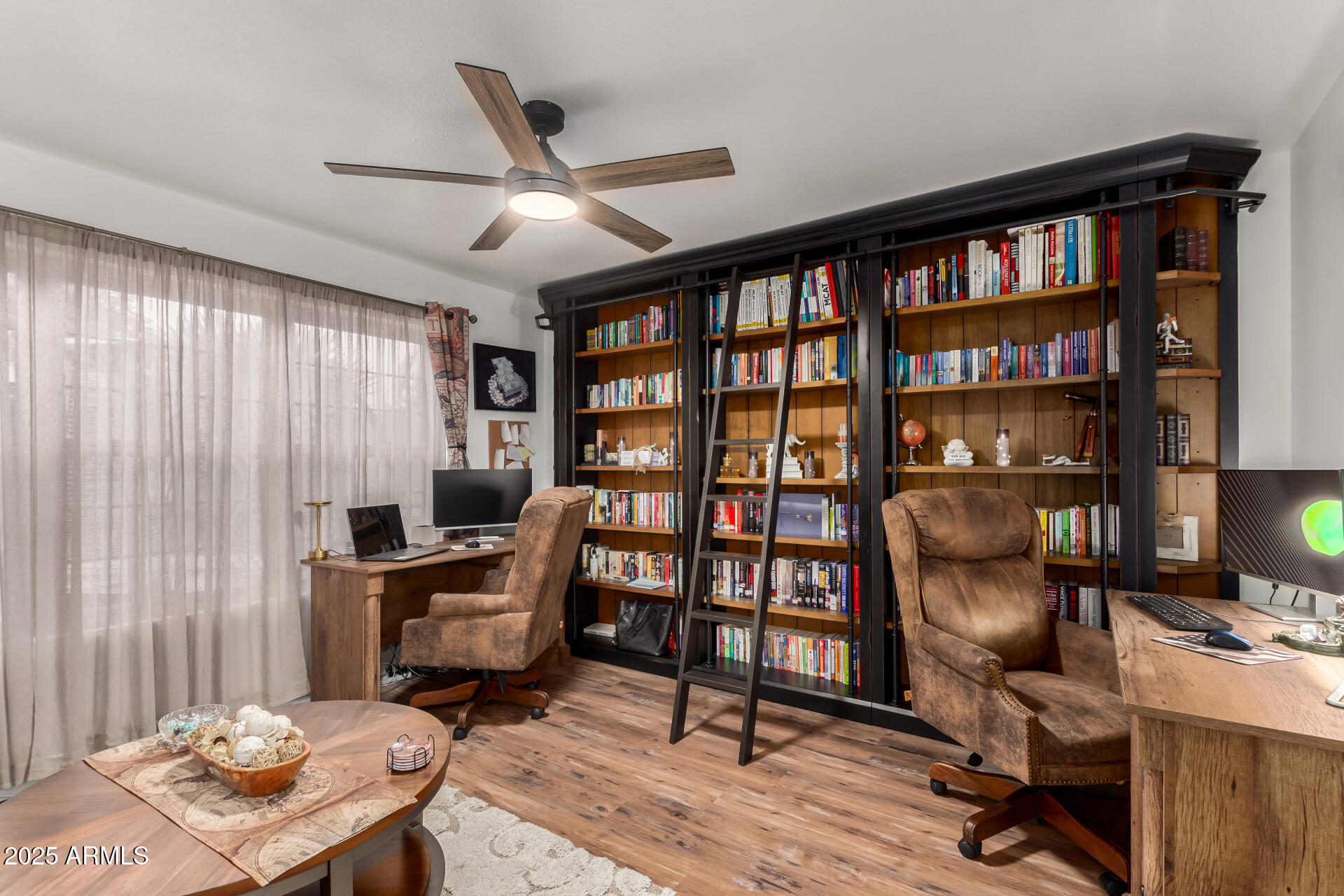 5956 East Phelps Road Scottsdale, AZ 85254 - Photo 42 of 60 a view of a workspace with furniture and a bookshelf