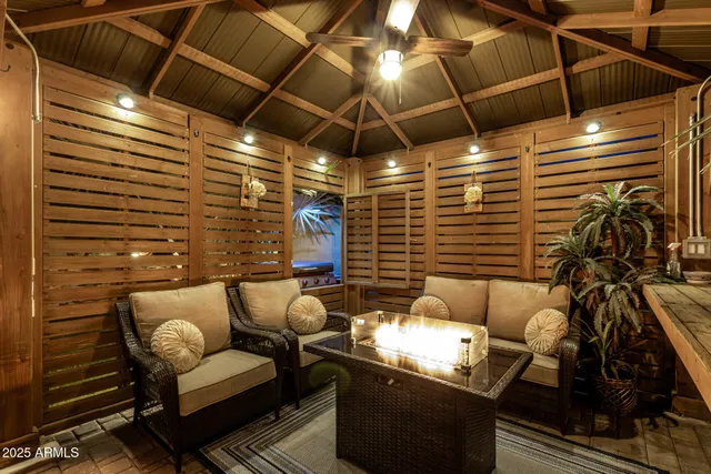 a view of a chair and table in backyard of the house