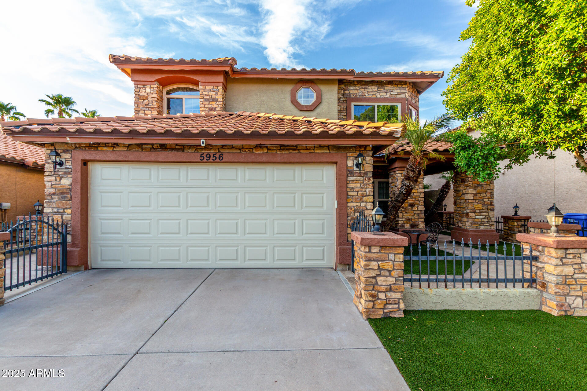5956 East Phelps Road Scottsdale, AZ 85254 - Photo 5 of 60 a front view of a house with a garden