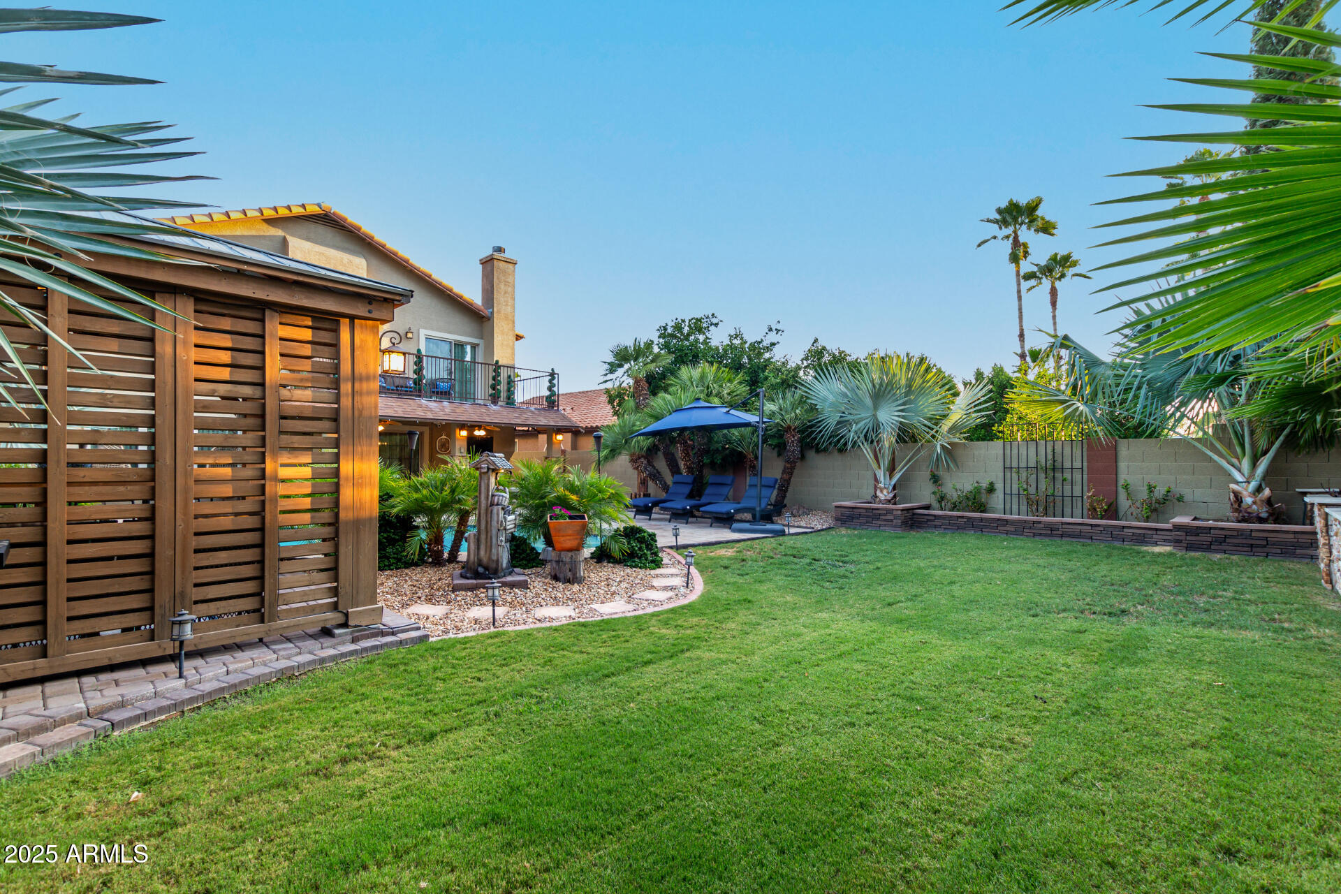 5956 East Phelps Road Scottsdale, AZ 85254 - Photo 58 of 60 a view of a chair and table in backyard of the house