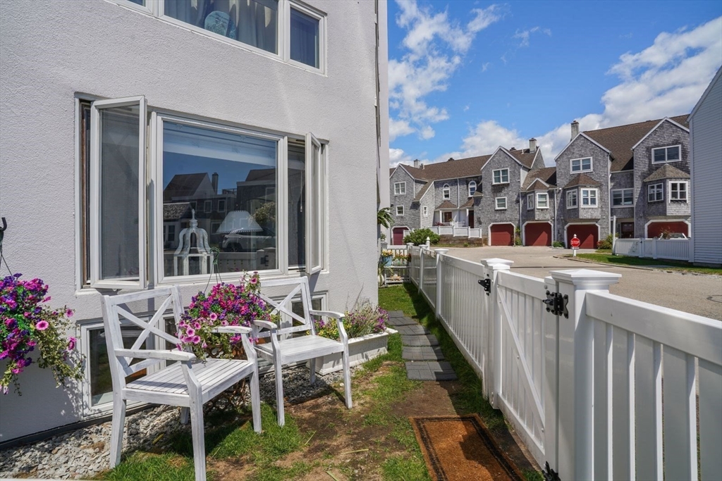 1 Commodore Court, Unit 104 Hull, MA 02045 - Photo 25 of 35 a view of a chairs and table in the balcony