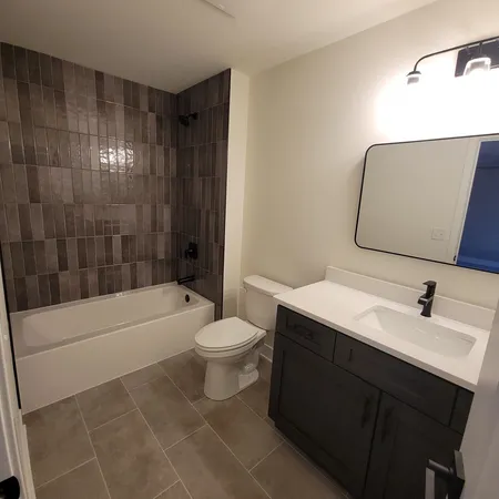 a bathroom with a sink a toilet and bathtub
