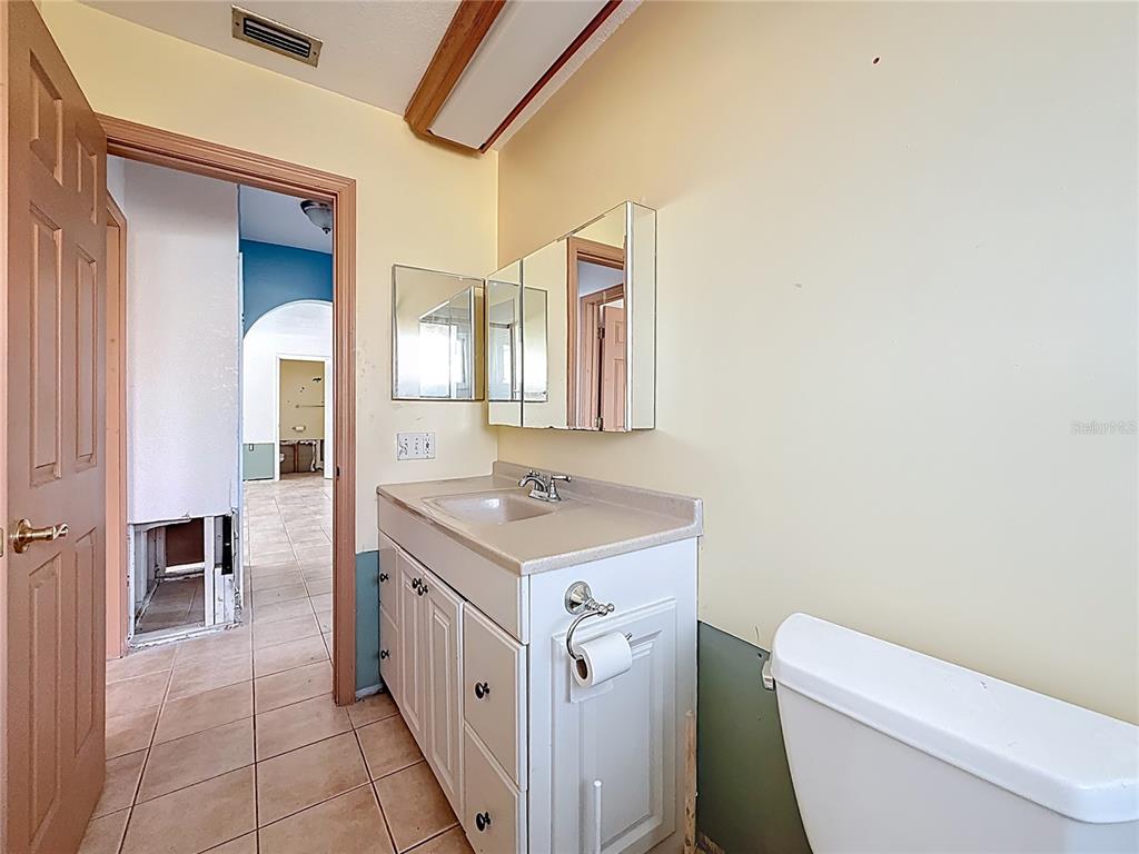 4869 Shell Stream Boulevard New Port Richey, FL 34652 - Photo 31 of 46 a bathroom with a sink a toilet and a mirror