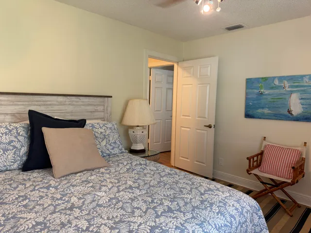 a bedroom with two beds and painting on the wall