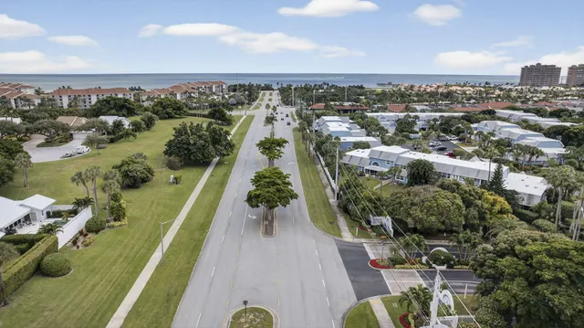 an aerial view of a houses with beach