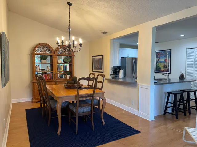 a view of a dining room with furniture and chandelier