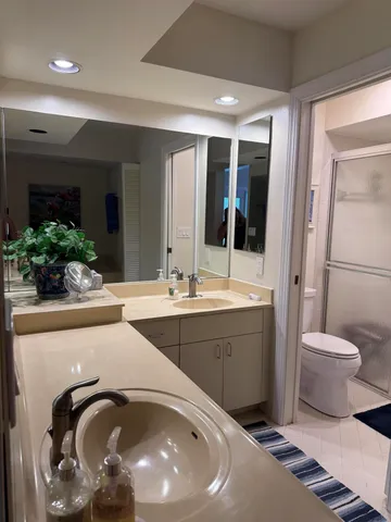 a bathroom with a toilet sink and mirror
