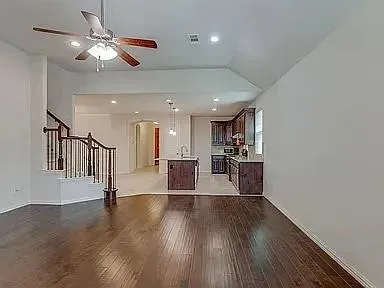 a view of a living room and kitchen with a hardwood floor