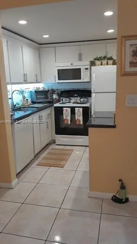 a room with blue lights with furniture and potted plants