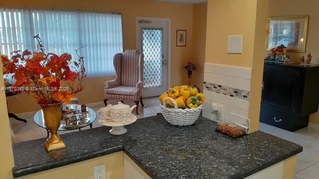 a bathroom with a granite countertop toilet sink and mirror