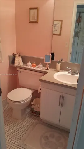 a bedroom with a bed and a flat tv screen on dresser