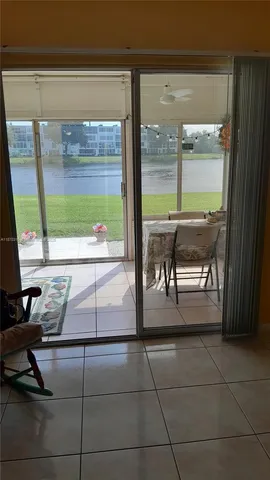 a living room with a table and a large window