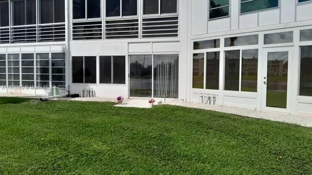 a view of a yard with outdoor seating and trees