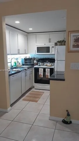 a dining room with furniture and chandelier