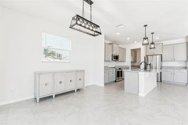 a view of a room with wooden floor and a window