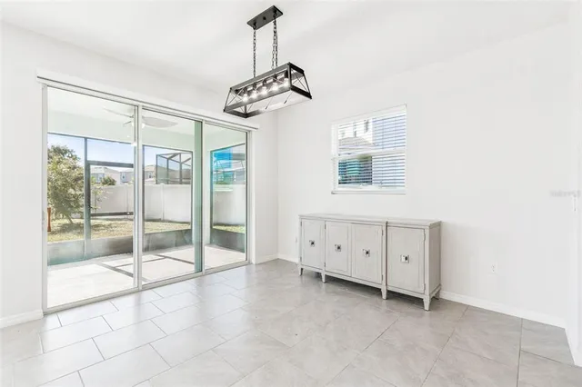 a bedroom with two beds and potted plant