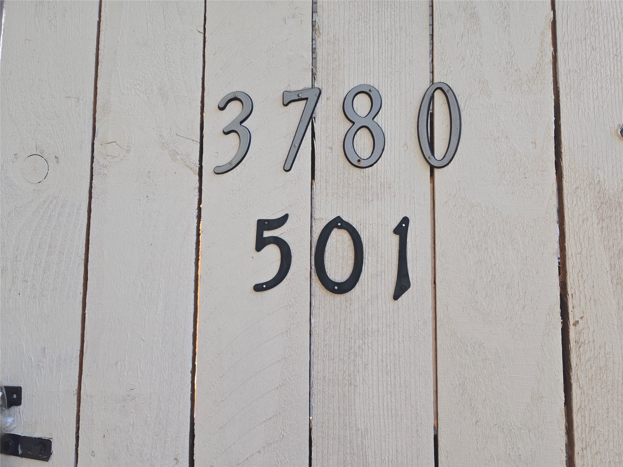 3780 Tanglewilde Street, Unit 501 Houston, TX 77063 - Photo 5 of 26 This photo shows a close-up of a house number, "3780 501," on a light-colored wooden fence.