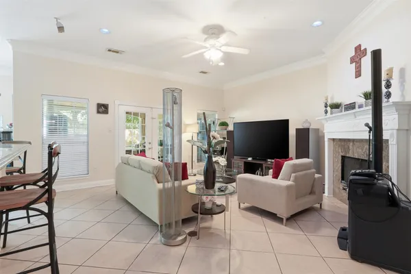 a living room with furniture a fireplace and a flat screen tv