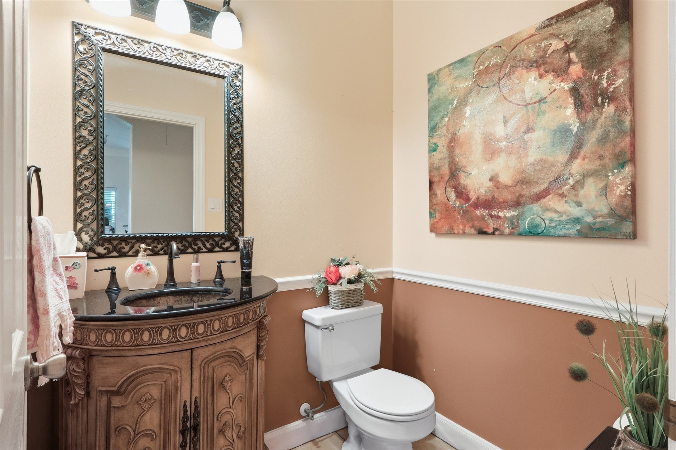 21411 Stargrass Drive Spring, TX 77388 - Photo 19 of 24 Stylish guest powder room with a custom vanity, elegant wall treatments, and a large ornamental mirror.