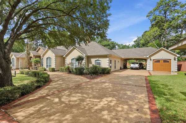 a view of house with wooden fence and a yard