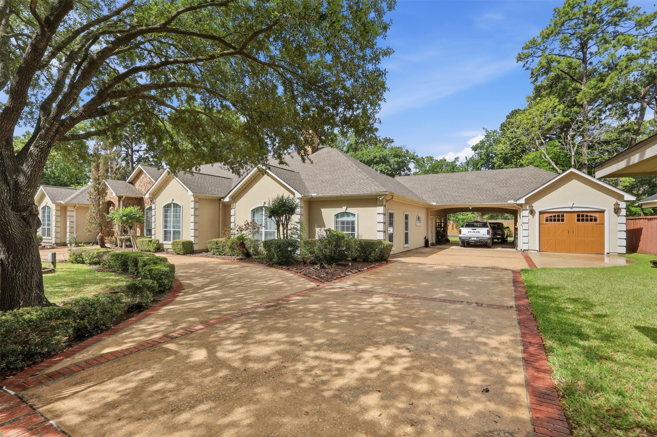 21411 Stargrass Drive Spring, TX 77388 - Photo 3 of 24 Grand front elevation featuring a wide circular drive and a convenient porte-cochère attached to a 2 car tandem air conditioned garage.