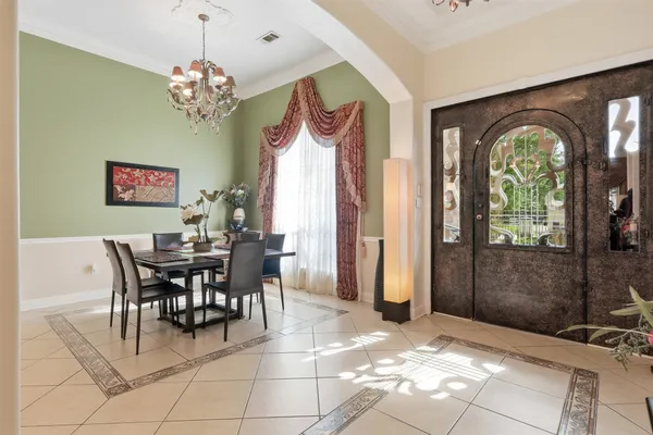 a view of a dining room with furniture and chandelier