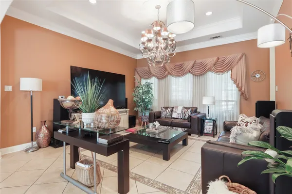 a living room with furniture chandelier and a chandelier
