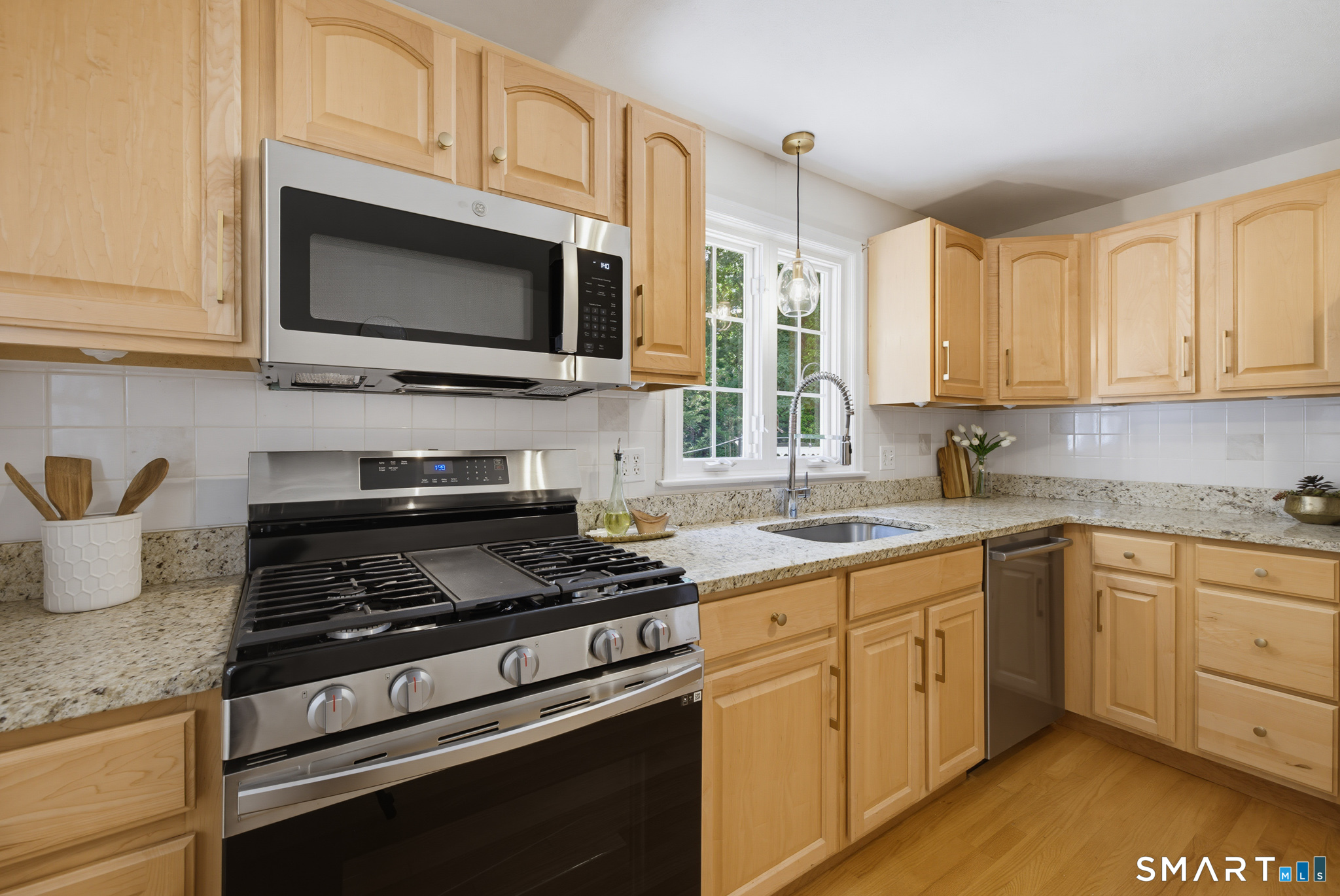 224 Spring Street Manchester, CT 06040 - Photo 8 of 39 a kitchen with stainless steel appliances granite countertop a stove microwave and sink