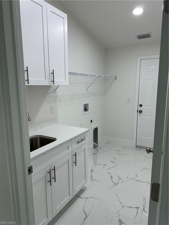 2530 Catron Circle Lehigh Acres, FL 33971 - Photo 14 of 27 a view of a kitchen with white cabinets