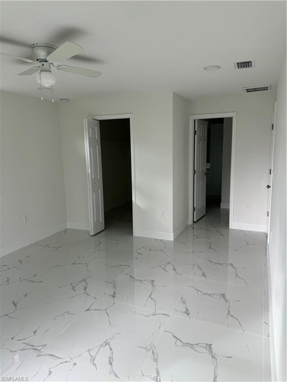 2530 Catron Circle Lehigh Acres, FL 33971 - Photo 15 of 27 an empty room with a ceiling fan and carpet