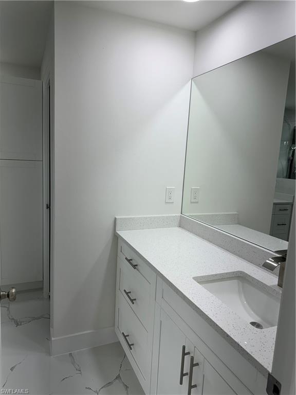 2530 Catron Circle Lehigh Acres, FL 33971 - Photo 17 of 27 a bathroom with a sink and a mirror