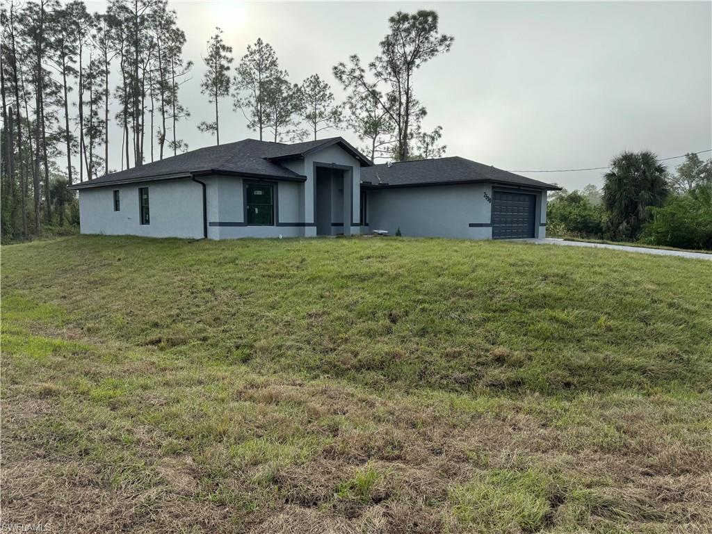 2530 Catron Circle Lehigh Acres, FL 33971 - Photo 2 of 27 a view of a house with a outdoor space