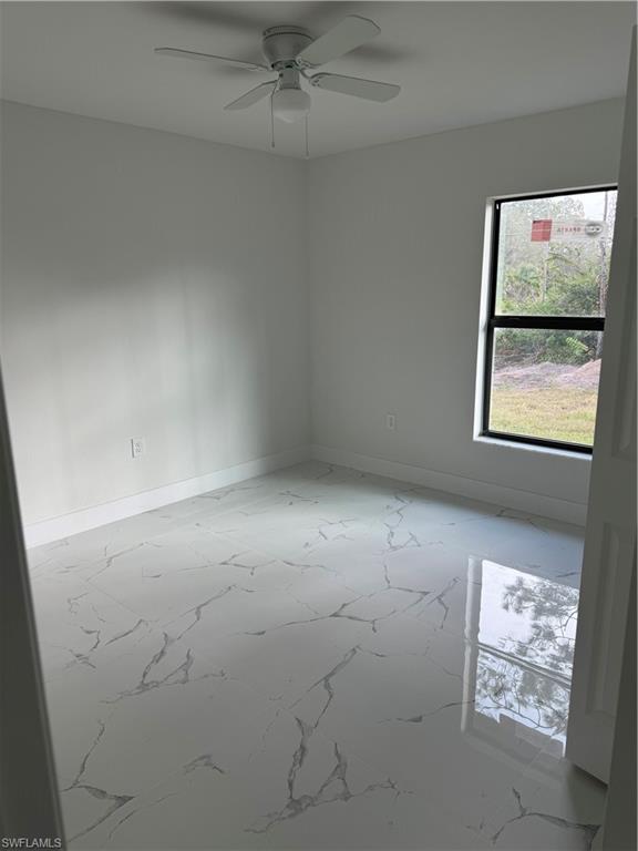 2530 Catron Circle Lehigh Acres, FL 33971 - Photo 22 of 27 an empty room with windows