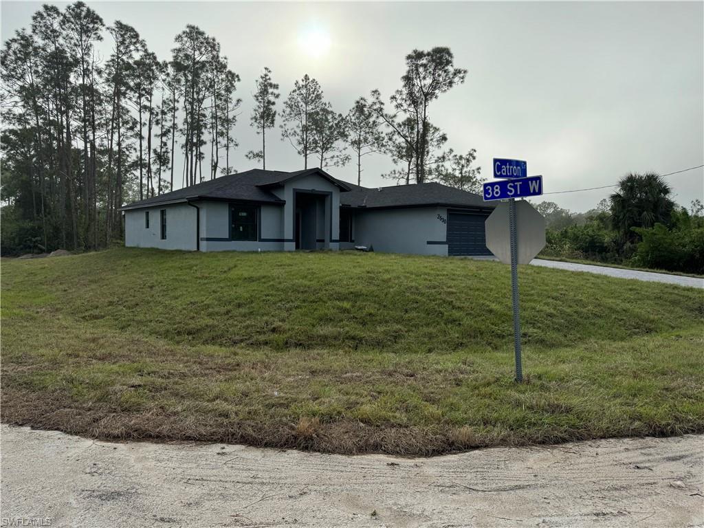 2530 Catron Circle Lehigh Acres, FL 33971 - Photo 3 of 27 a view of a house with a backyard