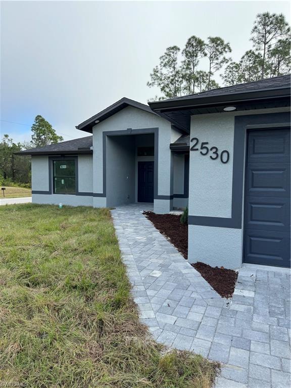 2530 Catron Circle Lehigh Acres, FL 33971 - Photo 4 of 27 a view of a house with porch