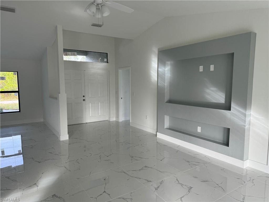 2530 Catron Circle Lehigh Acres, FL 33971 - Photo 5 of 27 a view of a livingroom with furniture and a flat screen tv